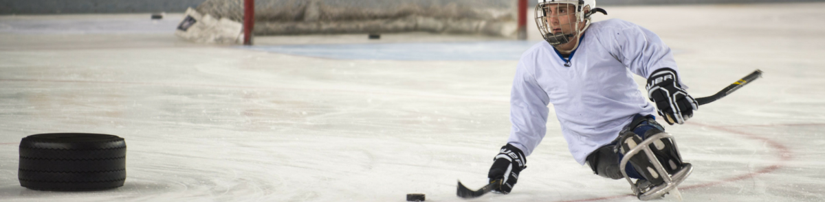 Student playing sled hockey
