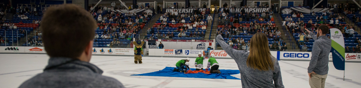 Sport studies students at a UNH hockey game Sport studies students working at a UNH hockey game