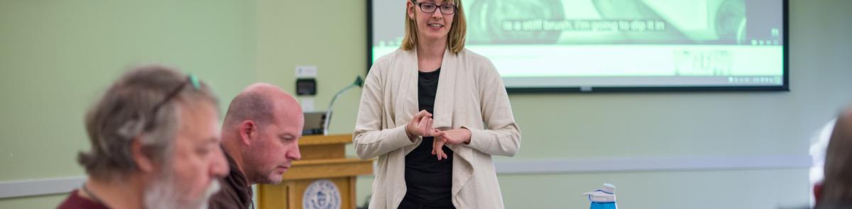 OT grad student working with members of a stroke survivors group