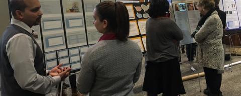 chhs research celebration attendees discussing posters