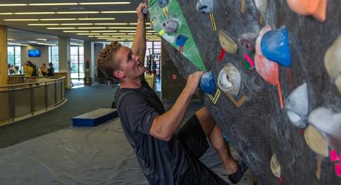 UNH Recreation Management student on a climbing wall