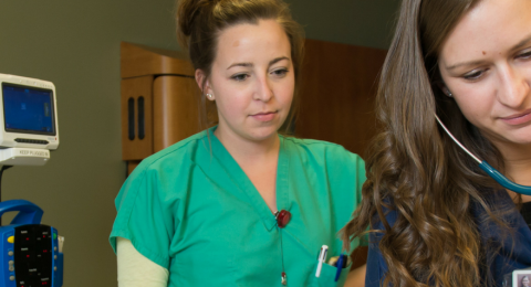 Students in the Primary Care Family Nurse Practitioner: Online (M.S.) program at UNH checking on a patient