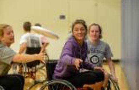 Wheelchair athletes playing Frisbee