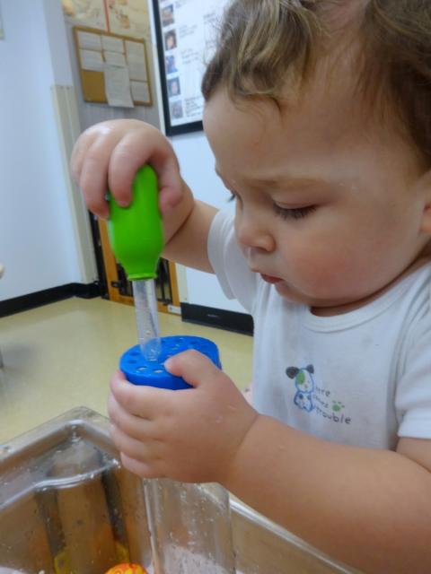 infant playing in the classroom