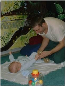 father playing with infant