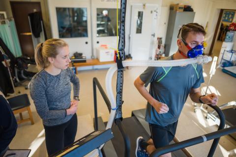 Faculty member and student doing an exercise test on another student in the exercise physiology laboratory