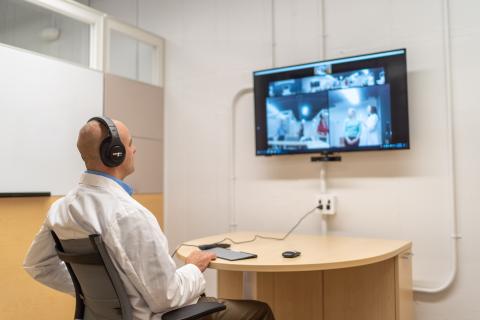 a person sitting in front of a television screen