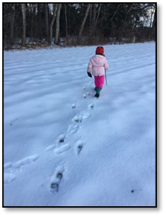 child walking through the snow
