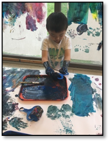 child using hands to paint
