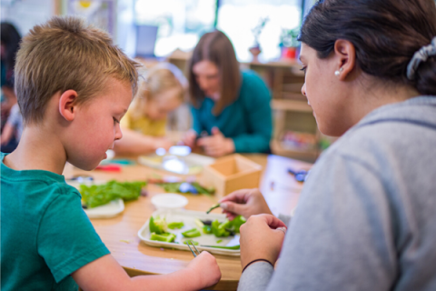 Dr. Nesbitt and student teacher engaging children in inquiry-based learning as they explore vegetable seeds