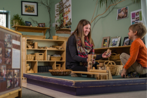 Teacher engaging in block play with preschool student