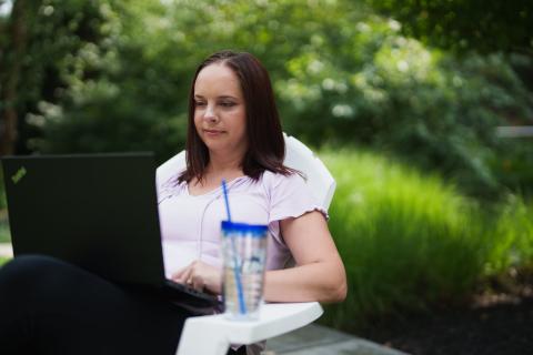 Student doing coursework outside
