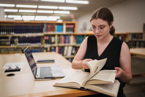 Student at a library, researching a book