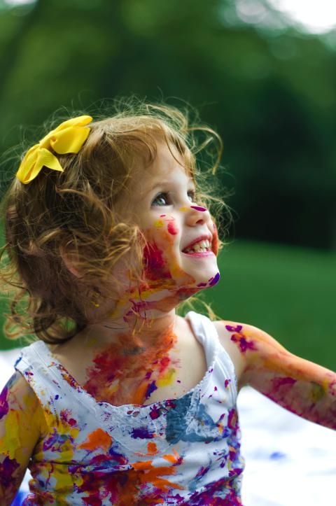 child covered in paint