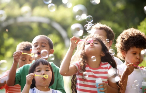 children blowing bubbles