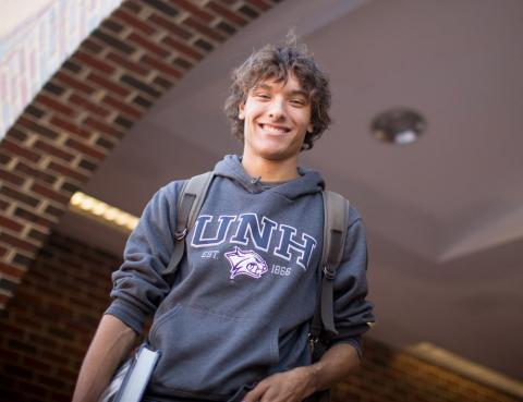 student posing in doorway on campus